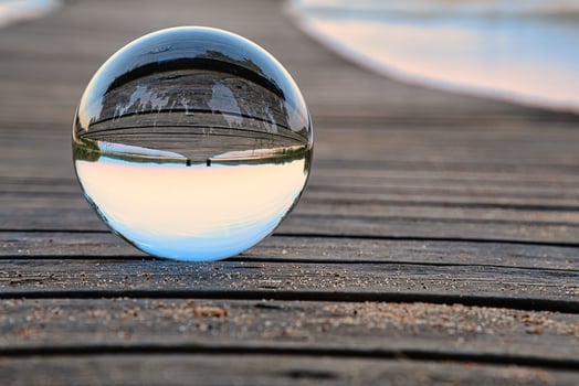 Glass ball on a wooden pier at a Swedish lake at evening hour. Nature Scandinavia photo