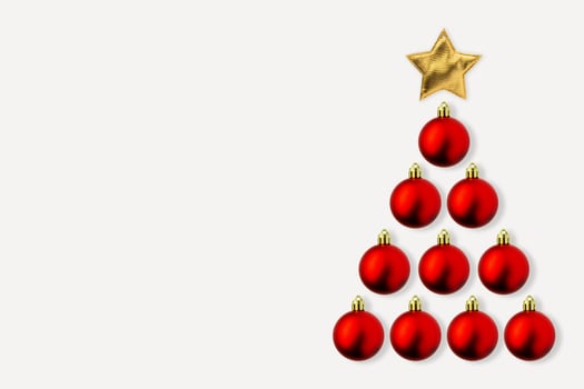 Christmas tree from red bauble and golden star on white background photo