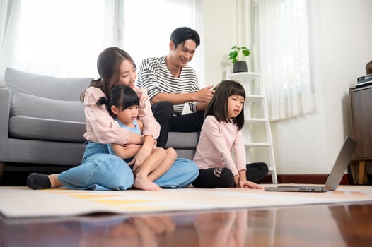 Asian family with children using laptop computer at home photo