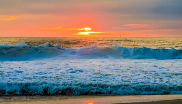 Colorful golden sunset big wave and beach Puerto Escondido Mexico. photo