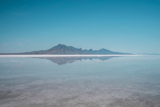 Scenic view of Bonneville salt flat and mountains with clear sky in background photo
