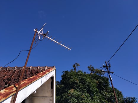 the roof of the house against the background of the bright blue sky photo