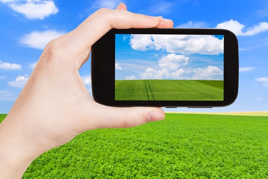 photo of green country field under blue sky