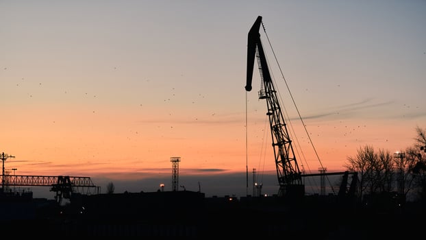 Silhouette of container crane on sunset background photo