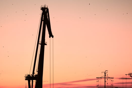 Silhouette of container crane on sunset background photo