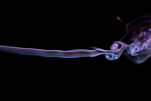 Multicolored smoke for aromatherapy relaxation on black background, beautiful swirled puffs of smoke photo