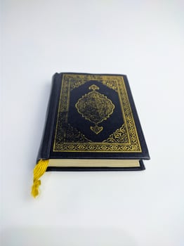 Islamic concept - The Holy Al Quran, on white background, with copy space photo