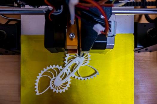 Modern 3D printer printing figure close-up macro 3d printer prints with orange plastic photo