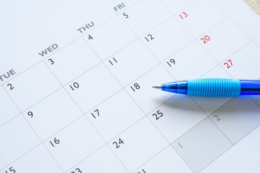 Blue pen on calendar page background business planning appointment meeting concept photo