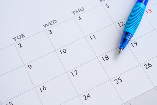 Blue pen on calendar page background business planning appointment meeting concept photo