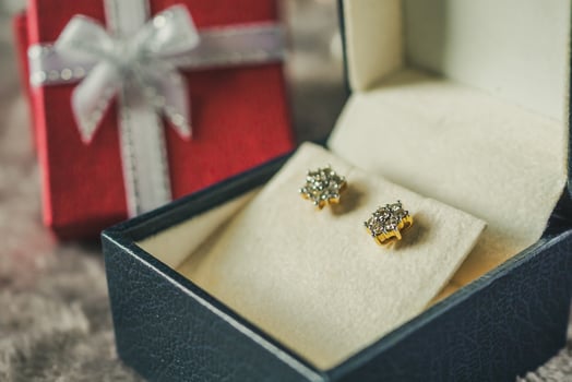Jewelry gold diamond earring with gift box background photo