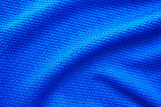 Blue football jersey clothing fabric texture sports wear background, close up top view photo