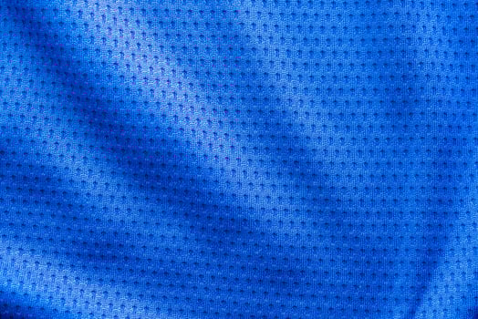 Blue color fabric sport clothing football jersey with air mesh texture background photo