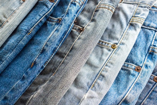 denim blue jeans stack texture background closeup photo