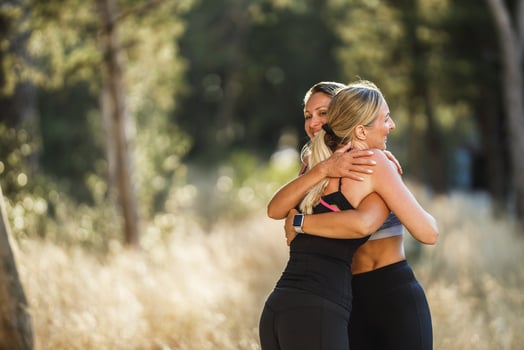 Two Female Friends Meet Outdoors To Do Some Exercise Together photo