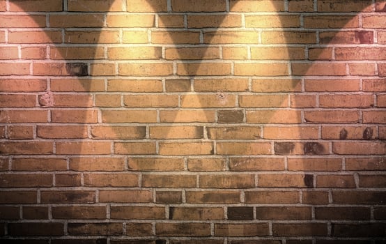 Aged and weathered brick wall textures with very bright spotlight illumination photo