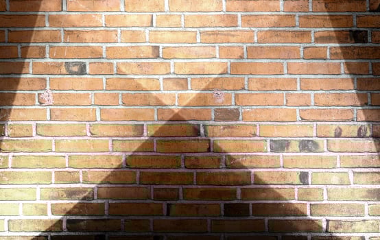 Aged and weathered brick wall textures with very bright spotlight illumination photo