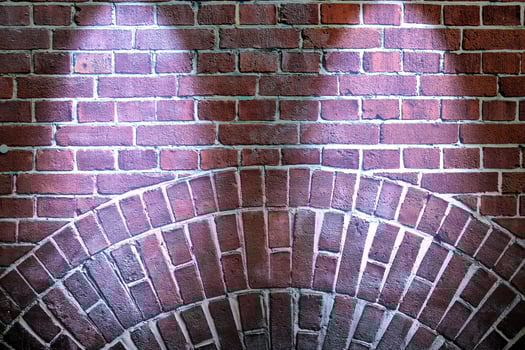 Aged and weathered brick wall textures with very bright spotlight illumination photo