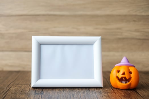 Orange pumpkin on table and frame with copy space for text. Happy Halloween day, Hello October, fall autumn season, Festive, party and holiday concept photo
