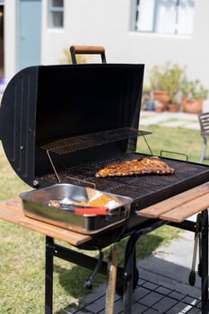 Vertical shot of meat being grilled on a grill outdoors photo
