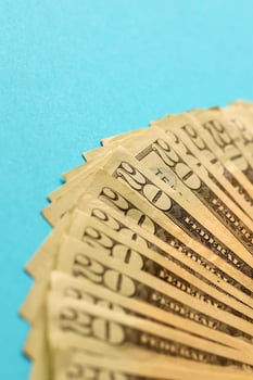 Big amount of old twenty dollar bills on blue background. Money earnings, payday or tax paying period photo