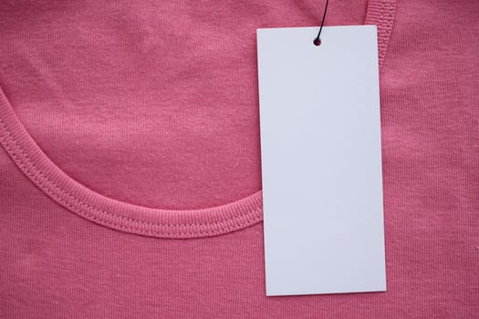 Blank white clothes tag label on new shirt photo