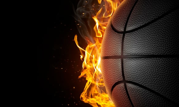 Basketball on fire on black background photo