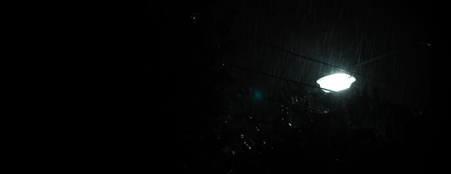 Raining Night and light. Rain Drops Falling in night at Bangkok Thailand in August raining season. photo