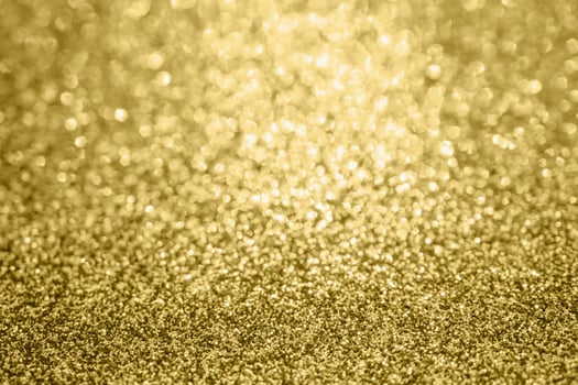 Abstract blur gold glitter sparkle defocused bokeh light background photo