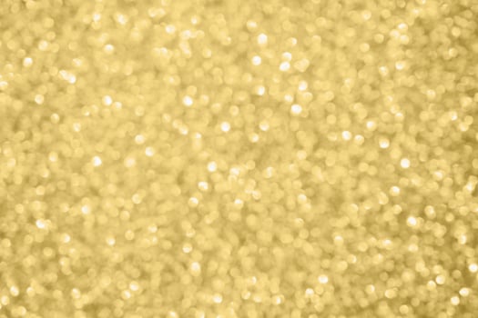 Abstract blur gold glitter sparkle defocused bokeh light background photo