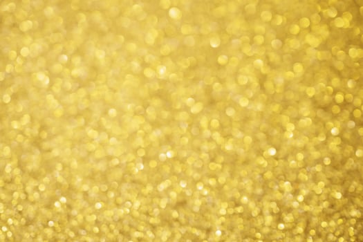 Abstract blur gold glitter sparkle defocused bokeh light background photo