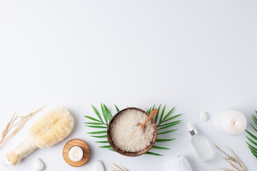 Spa treatment with natural skin care products flowers, towel and bowl on white background. Flat lay, copy space. photo