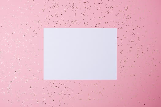 Christmas pink minimal background with mock up greetings card and confetti. Flat lay, copy space photo