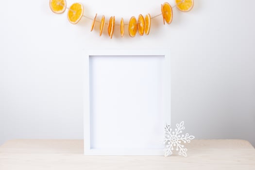 Zero waste Christmas natural decoration with white mock up frame on table. Close up, copy space photo