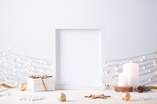 Christmas decorations with white frame and gift on white background. Close up, copy space photo