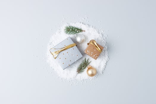 Christmas decorations with packaging gifts and Christmas tree on grey background. Flat lay, copy space photo