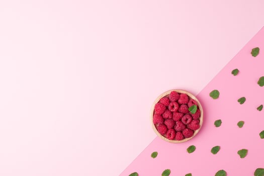 Creative summer background made from fresh berries and mint on pink. Flat lay, copy space. photo
