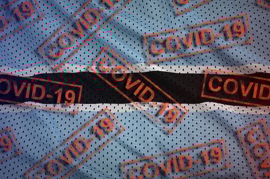 Botswana flag and many red Covid-19 stamps. Coronavirus or 2019-nCov virus concept photo
