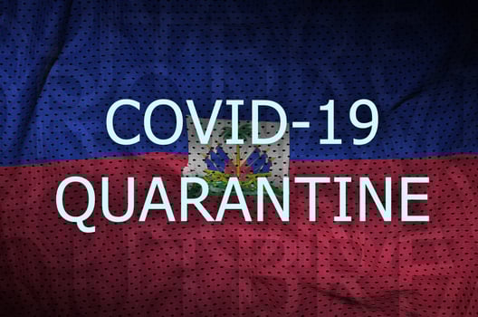 Haiti flag and Covid-19 quarantine inscription. Coronavirus or 2019-nCov virus photo