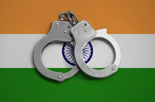 India flag  and police handcuffs. The concept of observance of the law in the country and protection from crime photo