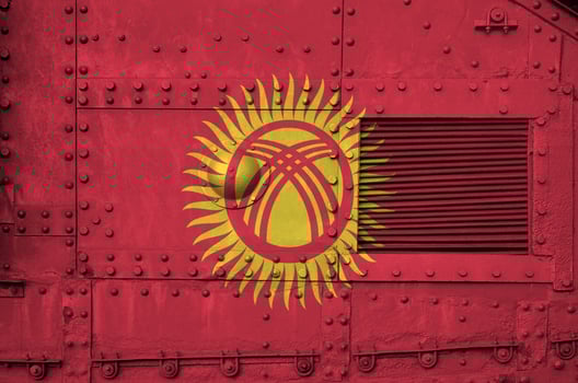 Kyrgyzstan flag depicted on side part of military armored tank closeup. Army forces conceptual background photo