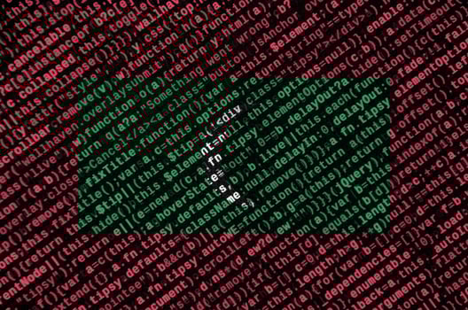Maldives flag  is depicted on the screen with the program code. The concept of modern technology and site development photo