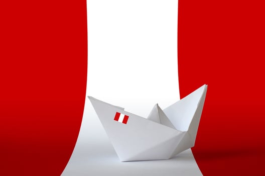 Peru flag depicted on paper origami ship closeup. Handmade arts concept photo