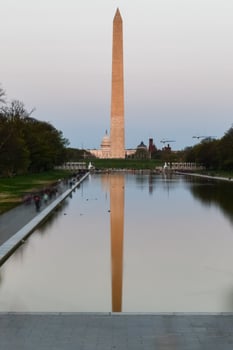 Washington Monument reflecting in the Lincoln Memorial Reflecting Pool at sunset in Washington, DC. photo