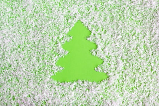 Winter composition with Christmas tree on a green background with artificial snow, flat lay. Greeting card for New Year with copy space. photo
