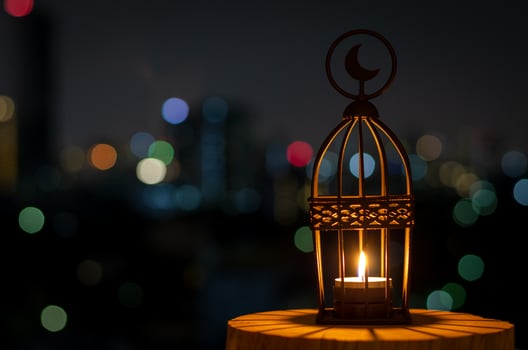 Beautiful Lantern that have moon symbol on top with city bokeh light on dark background. photo