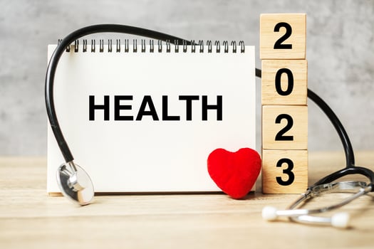 2023 Happy New Year for healthcare, Insurance, Wellness and medical concept. Stethoscope of doctor on table photo