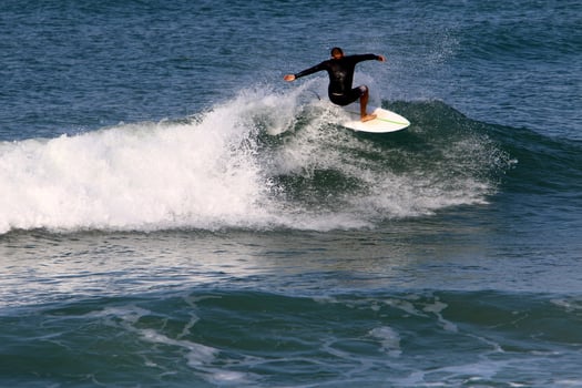Surfing on high waves on the Mediterranean Sea in northern Israel. photo