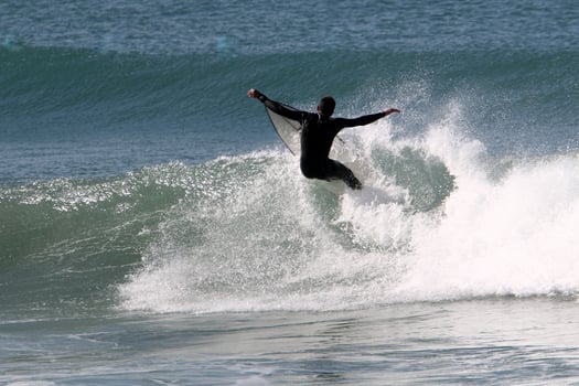 Surfing on high waves on the Mediterranean Sea in northern Israel. photo