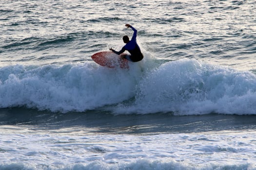 Surfing on high waves on the Mediterranean Sea in northern Israel. photo